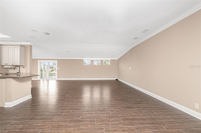 9150 Pine Cove Dr, Englewood, FL 34224 - unfurnished living room with dark wood-style flooring and crown molding