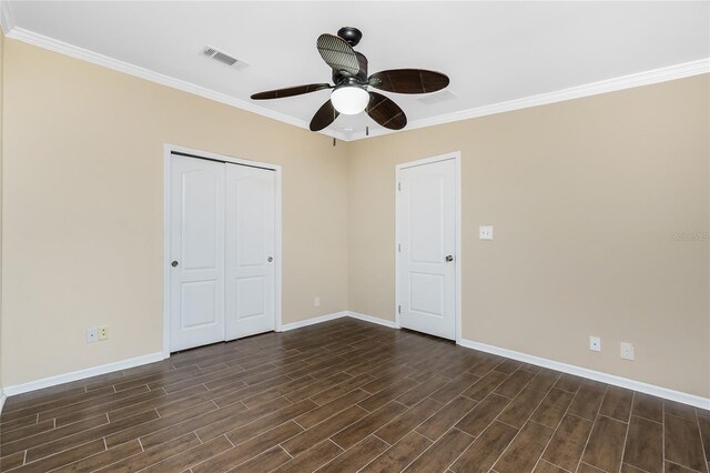 9150 Pine Cove Dr, Englewood, FL 34224 - unfurnished bedroom with dark wood-style floors, a closet, crown molding, and ceiling fan