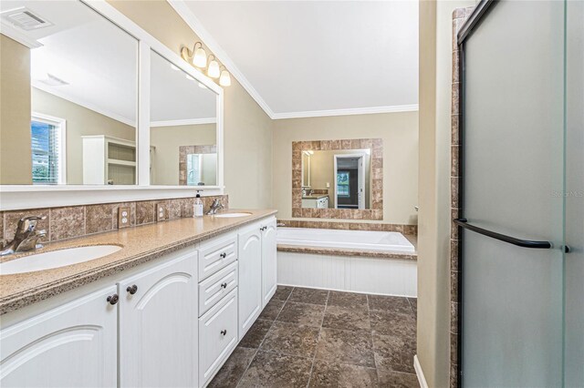 9150 Pine Cove Dr, Englewood, FL 34224 - bathroom with double vanity, crown molding, a garden tub, a stall shower, and backsplash