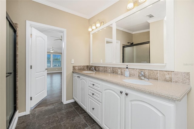 9150 Pine Cove Dr, Englewood, FL 34224 - bathroom featuring double vanity, a shower with door, crown molding, and a ceiling fan