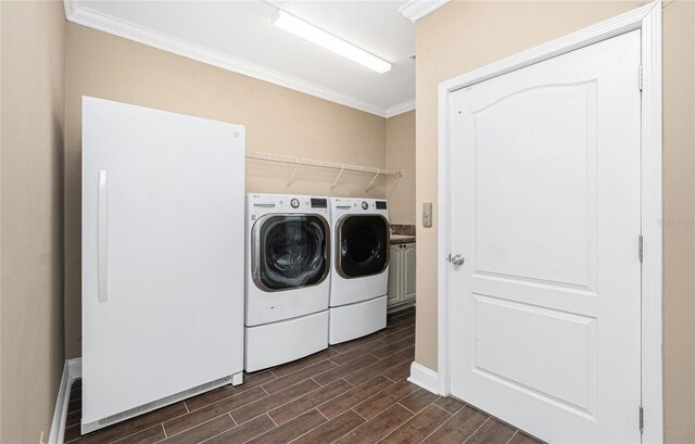 9150 Pine Cove Dr, Englewood, FL 34224 - laundry room with separate washer and dryer, ornamental molding, and wood finish floors