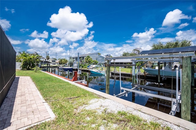 9150 Pine Cove Dr, Englewood, FL 34224 - dock area with boat lift, a water view, and a yard