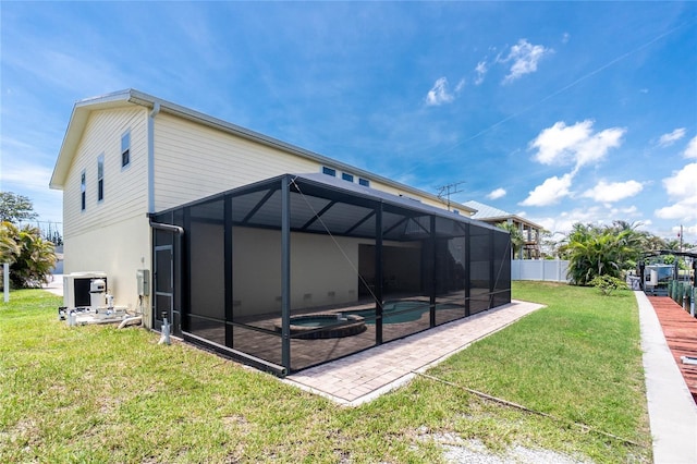 9150 Pine Cove Dr, Englewood, FL 34224 - back of house featuring a patio, a pool with connected hot tub, and glass enclosure