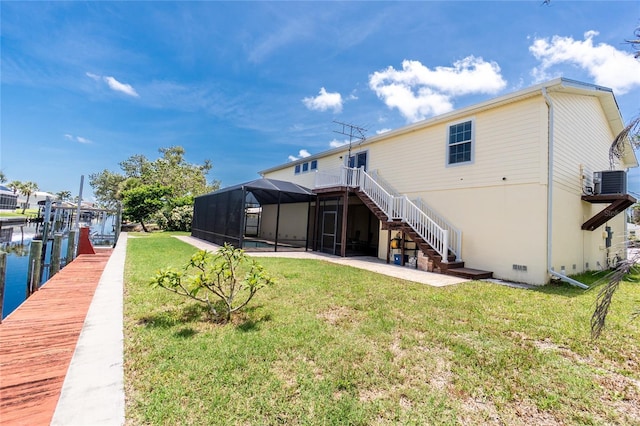 9150 Pine Cove Dr, Englewood, FL 34224 - rear view of property with stairway, a yard, a lanai, and a patio