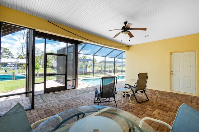9150 Pine Cove Dr, Englewood, FL 34224 - sunroom with ceiling fan, a swimming pool, and healthy amount of natural light