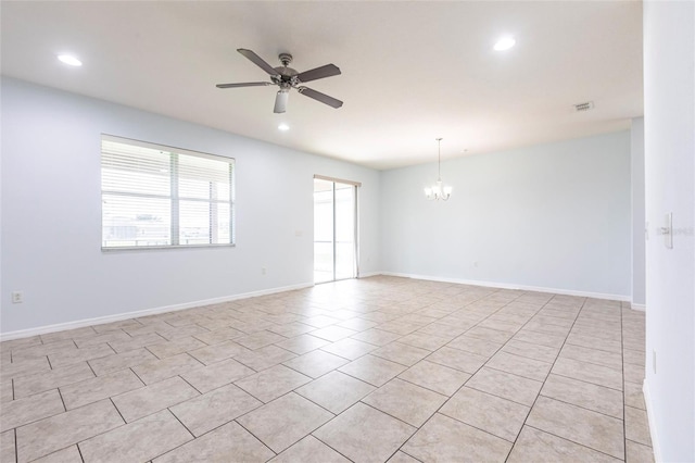 7318 61st St E, Palmetto, FL 34221 - spare room with a chandelier, recessed lighting, ceiling fan, and light tile patterned floors