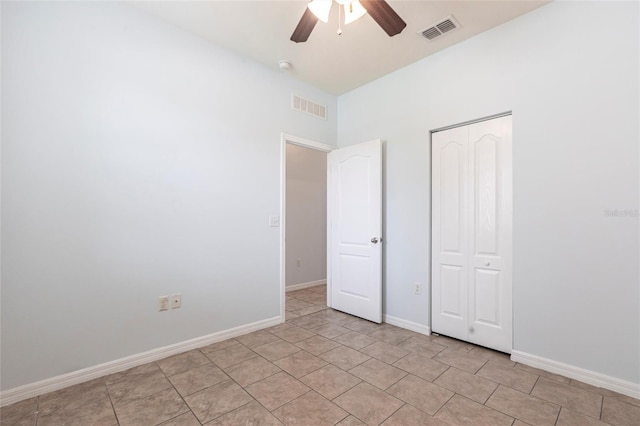 7318 61st St E, Palmetto, FL 34221 - unfurnished bedroom featuring a ceiling fan, a closet, and light tile patterned floors