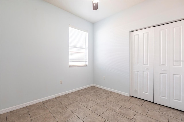 7318 61st St E, Palmetto, FL 34221 - unfurnished bedroom featuring a closet, light tile patterned floors, and ceiling fan