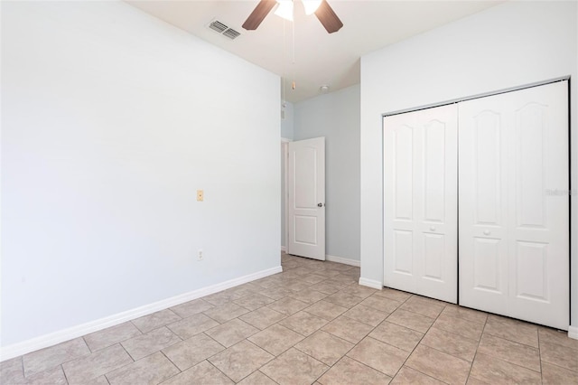 7318 61st St E, Palmetto, FL 34221 - unfurnished bedroom with a closet, light tile patterned floors, and a ceiling fan