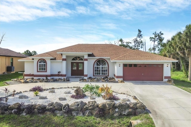 102 Marker Rd, Rotonda West, FL 33947 - mediterranean / spanish house with an attached garage, concrete driveway, stucco siding, and roof with shingles