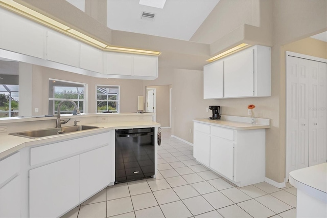 102 Marker Rd, Rotonda West, FL 33947 - kitchen featuring black dishwasher, light countertops, light tile patterned flooring, white cabinetry, and high vaulted ceiling