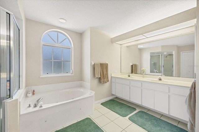 102 Marker Rd, Rotonda West, FL 33947 - bathroom featuring a stall shower, a whirlpool tub, double vanity, tile patterned floors, and a textured ceiling