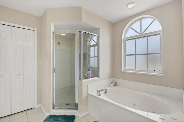 102 Marker Rd, Rotonda West, FL 33947 - bathroom featuring a closet, a shower stall, a tub with jets, and tile patterned flooring