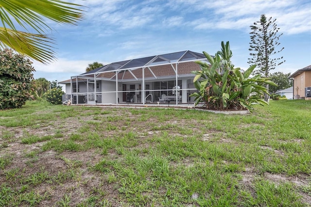 102 Marker Rd, Rotonda West, FL 33947 - rear view of house featuring glass enclosure