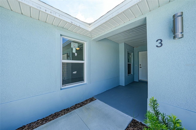 238 Boundary Blvd Unit 3, Rotonda West, FL 33947 - doorway to property featuring stucco siding and a patio area