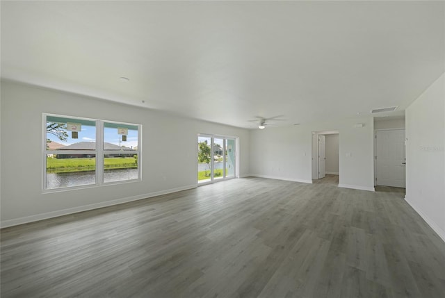 238 Boundary Blvd Unit 3, Rotonda West, FL 33947 - unfurnished living room with a ceiling fan and wood finished floors