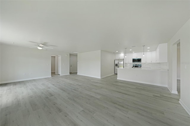 238 Boundary Blvd Unit 3, Rotonda West, FL 33947 - unfurnished living room with recessed lighting, a ceiling fan, and light wood-style floors