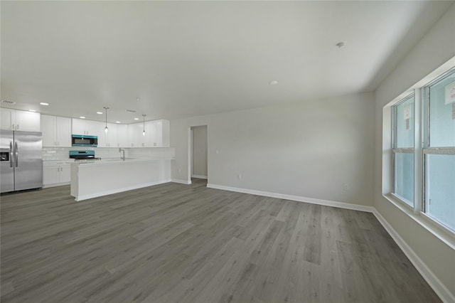 238 Boundary Blvd Unit 3, Rotonda West, FL 33947 - unfurnished living room with wood finished floors and recessed lighting