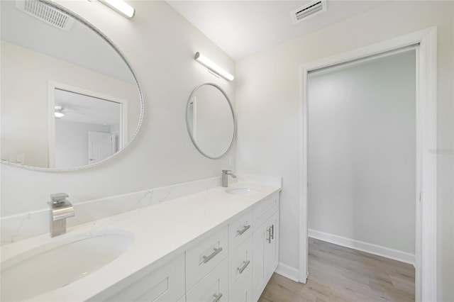238 Boundary Blvd Unit 3, Rotonda West, FL 33947 - bathroom featuring double vanity, wood finished floors, and ceiling fan