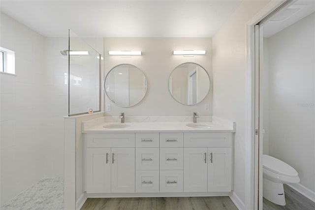 238 Boundary Blvd Unit 3, Rotonda West, FL 33947 - bathroom featuring double vanity, a walk in shower, and wood finished floors