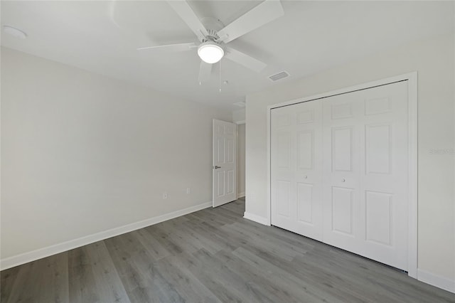 238 Boundary Blvd Unit 3, Rotonda West, FL 33947 - unfurnished bedroom featuring wood finished floors, a closet, and ceiling fan