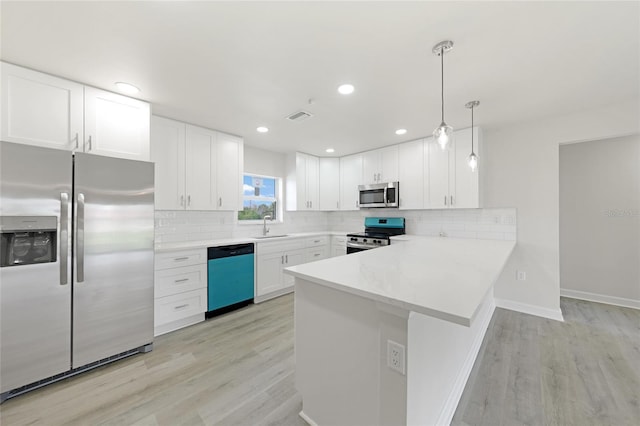 238 Boundary Blvd Unit 3, Rotonda West, FL 33947 - kitchen with stainless steel appliances, a peninsula, white cabinetry, light countertops, and tasteful backsplash
