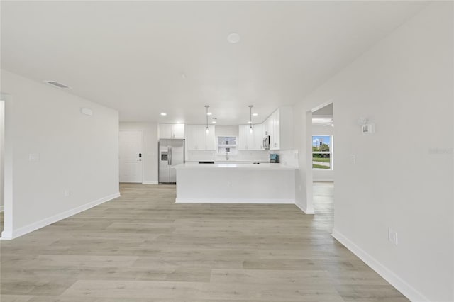 238 Boundary Blvd Unit 3, Rotonda West, FL 33947 - unfurnished living room featuring recessed lighting and light wood-style floors