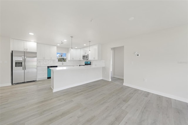 238 Boundary Blvd Unit 3, Rotonda West, FL 33947 - kitchen featuring stainless steel appliances, backsplash, recessed lighting, light countertops, and white cabinets