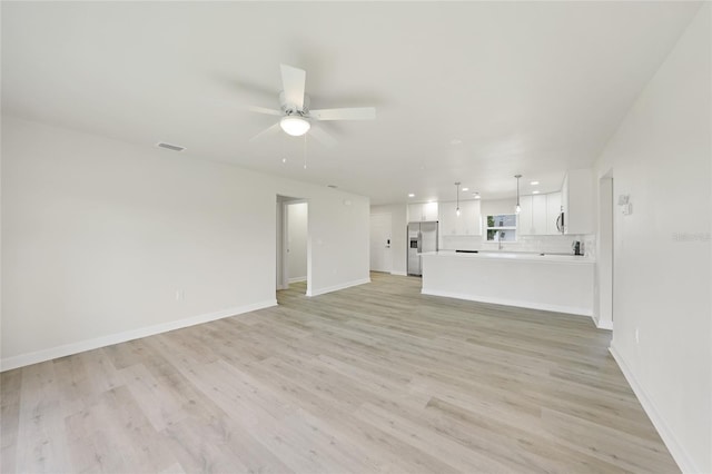 238 Boundary Blvd Unit 3, Rotonda West, FL 33947 - unfurnished living room with a ceiling fan, light wood-type flooring, and recessed lighting