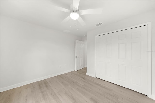 238 Boundary Blvd Unit 3, Rotonda West, FL 33947 - unfurnished bedroom with light wood-type flooring, a closet, and a ceiling fan