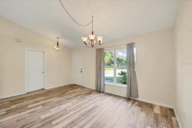 3768 Billingham Ln, North Port, FL 34288 - empty room with a chandelier, wood finished floors, and vaulted ceiling