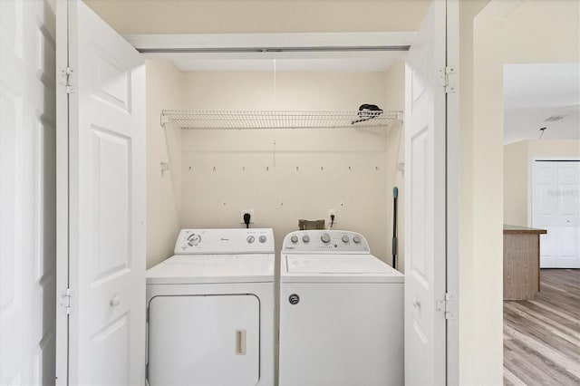 3768 Billingham Ln, North Port, FL 34288 - laundry area featuring washer and clothes dryer and wood finished floors