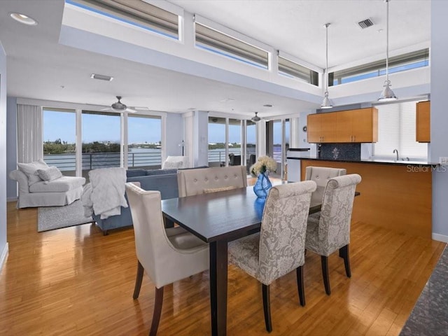 8041 Bay Pointe Dr, Englewood, FL 34224 - dining room featuring ceiling fan and light wood-style flooring