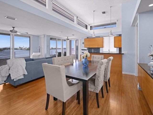 8041 Bay Pointe Dr, Englewood, FL 34224 - dining room featuring light wood-type flooring and ceiling fan