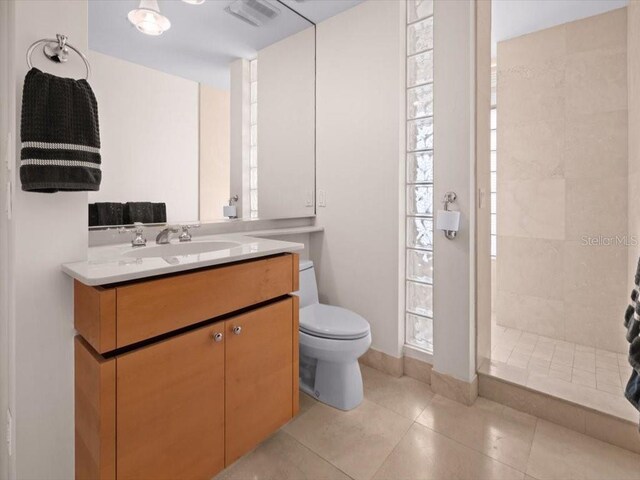8041 Bay Pointe Dr, Englewood, FL 34224 - full bath with vanity, a tile shower, and tile patterned flooring