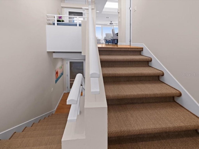 8041 Bay Pointe Dr, Englewood, FL 34224 - staircase featuring ceiling fan and baseboards