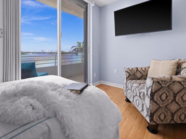 8041 Bay Pointe Dr, Englewood, FL 34224 - bedroom featuring wood finished floors, access to outside, and a water view