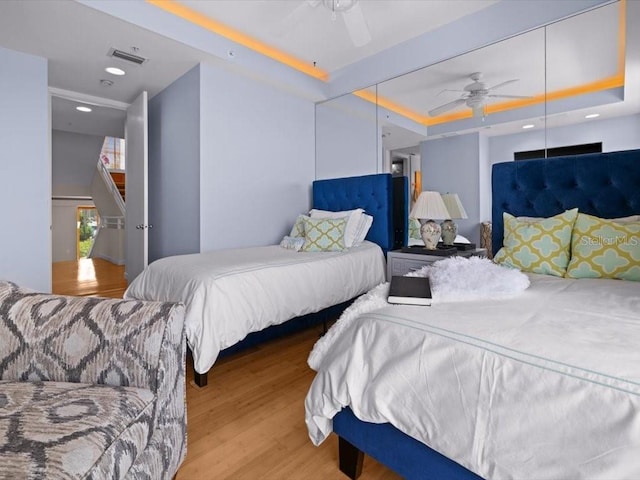 8041 Bay Pointe Dr, Englewood, FL 34224 - bedroom featuring wood finished floors, a tray ceiling, and recessed lighting