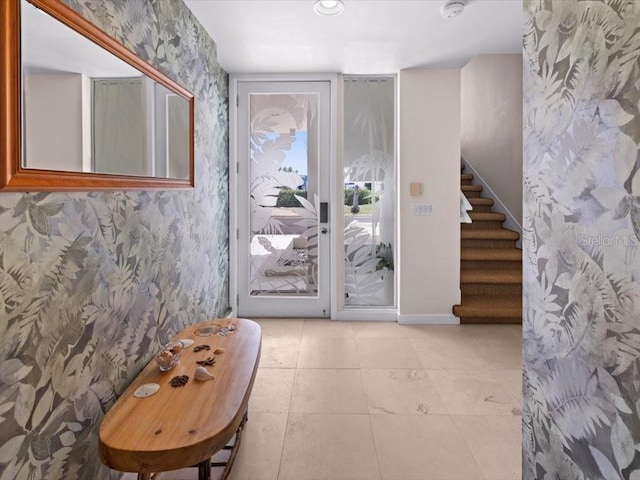 8041 Bay Pointe Dr, Englewood, FL 34224 - entrance foyer featuring wallpapered walls, stairs, and tile patterned flooring