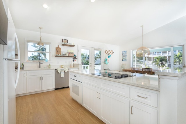 100 S Gulf Blvd, Placida, FL 33946 - kitchen featuring white appliances, light wood-type flooring, french doors, white cabinets, and open shelves