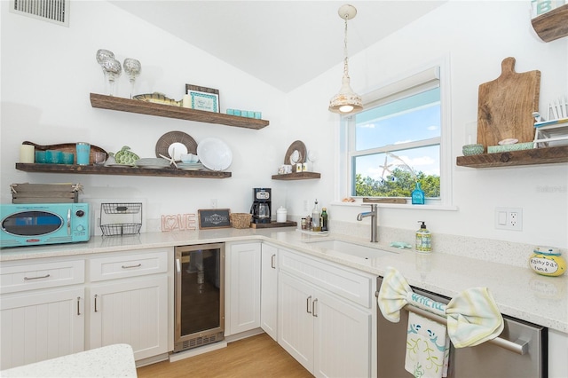 100 S Gulf Blvd, Placida, FL 33946 - kitchen with open shelves, beverage cooler, vaulted ceiling, white cabinetry, and hanging light fixtures