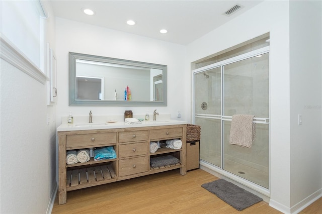 100 S Gulf Blvd, Placida, FL 33946 - bathroom with double vanity, wood finished floors, a stall shower, and recessed lighting