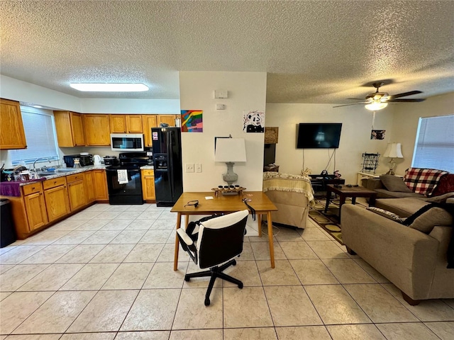 26591 Fairway Dr Unit A & B, Punta Gorda, FL 33982 - kitchen featuring black appliances, open floor plan, a textured ceiling, brown cabinetry, and light tile patterned flooring