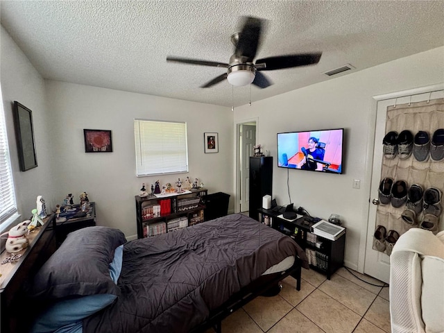 26591 Fairway Dr Unit A & B, Punta Gorda, FL 33982 - bedroom featuring multiple windows, light tile patterned flooring, a textured ceiling, and ceiling fan