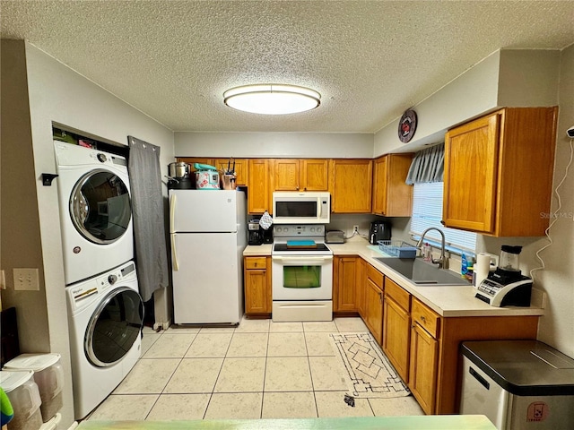 26591 Fairway Dr Unit A & B, Punta Gorda, FL 33982 - kitchen with white appliances, estacked washer and dryer, brown cabinets, light countertops, and a textured ceiling