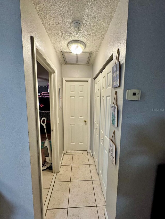 26591 Fairway Dr Unit A & B, Punta Gorda, FL 33982 - hall featuring a textured ceiling, light tile patterned floors, and a textured wall