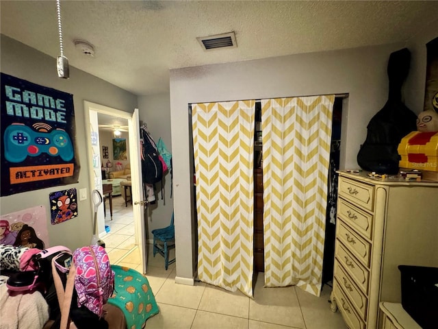 26591 Fairway Dr Unit A & B, Punta Gorda, FL 33982 - bedroom featuring light tile patterned floors and a textured ceiling
