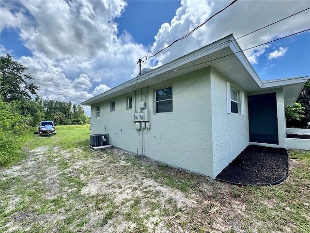 26591 Fairway Dr Unit A & B, Punta Gorda, FL 33982 - view of property exterior with stucco siding and a central air condition unit