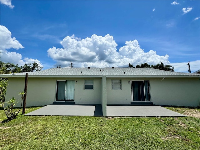 26591 Fairway Dr Unit A & B, Punta Gorda, FL 33982 - back of property featuring a patio, stucco siding, and a yard