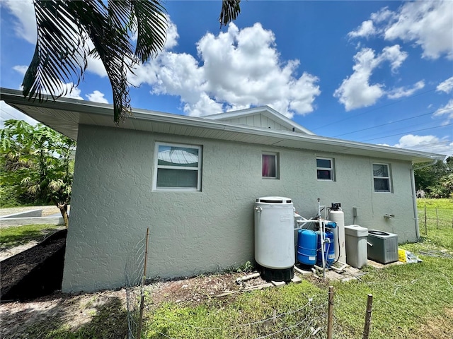 26591 Fairway Dr Unit A & B, Punta Gorda, FL 33982 - view of side of home with stucco siding and a central AC unit
